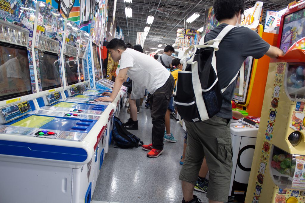 People playing arcade games In Yodobashi Camera