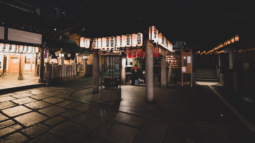 Small shrine at night with lanterns